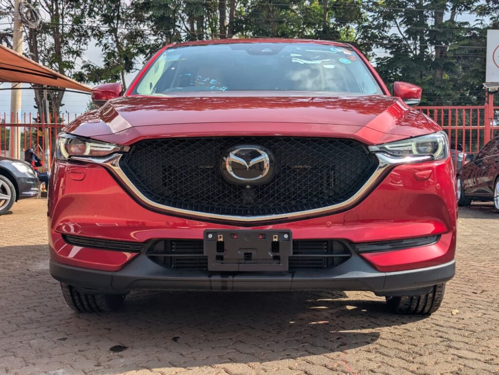 2018 Mazda CX-5 in wine red exterior with tan brown leather interior at Axis Motors Limited.